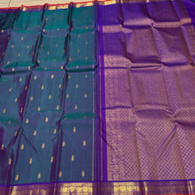 Sahana- Gorgeous Dual tone Lavendarish Blue with Purple Small Borders with orange selvedges with Buttas Handwoven Pure Jari Kanjivaram Silk with rich pallu and contrast woven blouse