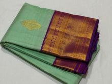 Vaibhogam- Beautiful Pista Green with Purple Handwoven Pure Jari Korvai Kanjivaram Silk with Buttas woven body rich borders pallu and contrast woven blouse