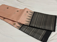Saraswati-Gorgeous Handwoven Pure Zariless Korvai Kanjivaram Silk in a beautiful and rare peachish sandal shade with Black combination with beautiful kasuti style buttas woven beautiful body with varisaipet borders rich pallu and contrast woven blouse