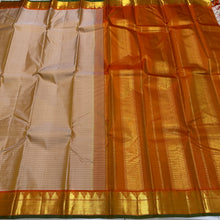 Sahana- Beautiful Biscuit beige with Orange Handwoven Pure Jari Kanjivaram Silk with muthukattam woven body with bawanchi temples and zigzags woven borders with green selvedges rich seer pallu and contrast orange blouse.