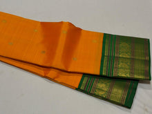 Vaibhogam-Stunning Mango Orange with Emerald Green Handwoven Pure Jari Korvai Kanjivaram Silk with Buttas woven body beautifully woven rich borders pallu and contrast woven green blouse