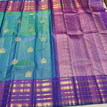 Vaibhogam- Gorgeous Peacock Bluish Green with Purple Handwoven Pure Jari Kanjivaram Silk in Vairaoosi with Buttas woven beautiful body with varisaipet borders rich pallu and contrast purple vairaoosi blouse