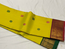 Vaibhogam- Stunning Lemoney Green tinted Yellow with Burgundy Maroon in a Handwoven Pure Jari Korvai Kanjivaram Silk with beautiful pattu buttas woven body rich borders gorgeous pallu and contrast woven blouse