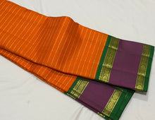 Vaibhogam- Gorgeous Orange with Emerald Green Handwoven Pure Jari Korvai Kanjivaram Silk with beautiful jari veldhari stripes and silk thread striped body with beautiful doublepet borders with rich pallu and contrast woven blouse
