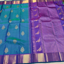 Sahana- Stunning Peacock Bluish Green with Purple Handwoven Pure 2g Jari Kanjivaram Silk with Muthukattam and Buttas woven beautiful body with rich bawanchi borders gorgeous kalakshetra kili pallu and contrast purple blouse