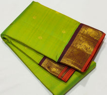 Vaibhogam-Gorgeous Sneha Green with Deep Maroonish Brown Handwoven Pure Jari Korvai Kanjivaram Silk with beautiful kolam buttas woven body with rich borders with orange selvedes gorgeous pallu with polka dots woven and contrast woven blouse