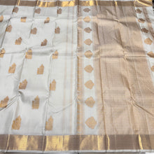 Gorgeous Offwhite with Gold Combination in Handwoven Pure Kanjivaram Silk Saree with rich Peacock driven chariot motifs woven all over the body with beautiful and intricate borders rich woven pallu and blouse with Zari strips