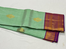 Vaibhogam- Beautiful Pista Green with Purple Handwoven Pure Jari Korvai Kanjivaram Silk with Buttas woven body rich borders pallu and contrast woven blouse