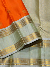 Vaibhogam-Gorgeous Orange with Elaichi Green Handwoven Pure Jari Korvai Kanjivaram Silk with beautiful buttas woven body with rich rudrakshas and jari lines striped borders gorgeous pallu and contrast woven blouse