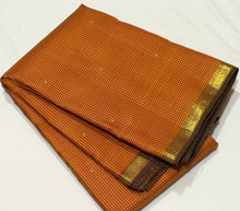Saranga- Beautiful Burnt Orange with Black Buttas with Small borders Handwoven Pure Jari Podikattam Checked body with rich yazhis elephants mayil chakram woven gorgeous pallu and contrast black blouse