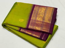 Vaibhogam -Mesmerizing Sneha Green with Deep Purple Handwoven Pure Jari Korvai Kanjivaram Silk with Mayil Chakram Buttas Woven Body with Gorgeous Temples woven intricate borders rich pallu and contrast woven blouse