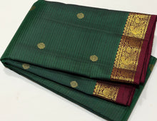 Vaibhogam- Gorgeous Bottle Green with Deep Maroon Handwoven Pure 2g Jari Korvai with Buttas Kanjivaram Silk with Self striped body with beautiful small borders rich pallu and contrast woven maroon blouse
