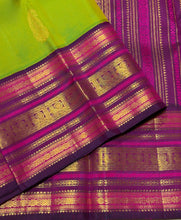 Vaibhogam- Mesmerising Parrot Green with Deep Magenta Handwoven Pure Jari Korvai Buttas Woven Kanjivaram Silk with beautiful varisaipet borders gorgeous pallu and contrast woven blouse