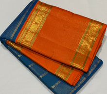 Vaibhogam- Gorgeous Peacock Blue with Orange Handwoven Pure Jari Korvai Kanjivaram Silk with Vairaoosi and Veldhari Striped body with rich doublepet borders with vairaoosi woven middle portions with gorgeous pallu and contrast woven beautiful blouse