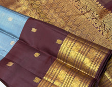 Vaibhogam-Beautiful Pastel Blue with Dark Brown Handwoven Pure Jari Korvai Kanjivaram Silk with Vairaoosi with buttas woven middle body with coffee brown buttas woven lower body and rich broad borders gorgeous pallu and contrast woven blouse