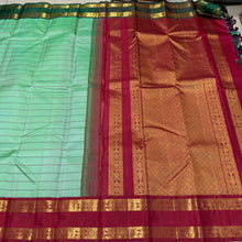 Vaibhogam- Beautiful Pista Green with Ganga Jamuna Borders Handwoven Pure Jari Korvai Kanjivaram Silk in bottle green and deep red with Neliveldhari woven beautiful body with fish woven doublepet borders rich pallu and contrast woven blouse