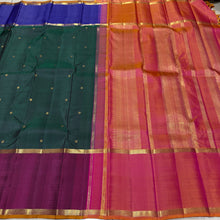 Sahana- Stunning Bottle Green with Ganga Jamuna Borders with buttas with contrast kanakambaram Orange Pallu and blouse in a beautiful Handwoven Pure 2g Jari Kanjivaram Silk Beauty