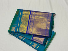 Gorgeous Peacock Blue Green with Royal Blue Handwoven Pure Jari Kanjivaram Silk Saree with Rettaikili motifs in Jari Checked body rich borders Pallu and Contrast woven blouse