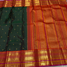 Vaibhogam- Gorgeous Bottle Green with Orange Handwoven Pure Jari Korvai Kanjivaram Silk with beautiful buttas woven body with rich varisaipet borders beautiful pallu and contrast woven blouse with Pink  selvedges