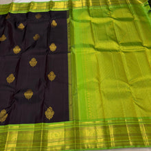 Vaibhogam- Gorgeous Deep Blackish Kanchana Brown with Parrot Green Handwoven Pure Jari Korvai with Buttas Kanjivaram Silk with beautiful double peacock motifs woven in a clover shaped motif with rich borders pallu and contrast woven blouse