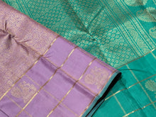 Sahana-Mesmerizing Lavendar with Turquoise Green Brocade Handwoven Pure Jari Kanjivaram with Jari checked borders with peacocks woven with rich turquoise pallu and contrast woven blouse.