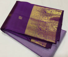 Vaibhogam- Mesmerizing Lavendar with Purple Handwoven Pure 2g Jari KanjivaramSilk with Jarioosi checked body with beautiful mayil chakram motifs woven middle borders with beautiful long and short borders pallu and contrast woven blouse