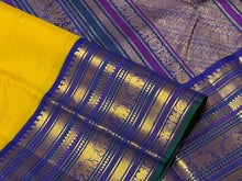 Vaibhogam- Stunning Yellow with Royal Blue Handwoven Pure Zari Korvai Kanjivaram Silk with Buttas Rich Varisaipet Borders gorgeous Meenakari work Pallu and Contrast woven blouse