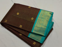 Vaibhogam- Gorgeous Coffee Brown with Turquoise Blue Handwoven Pure Jari Korvai Kanjivaram Silk with Vairaoosi woven body with mayil chakram buttas beautiful rich pallu and contrast oosi woven blouse