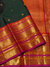 Vaibhogam- Gorgeous Bottle Green with Orange Handwoven Pure Jari Korvai Kanjivaram Silk with beautiful buttas woven body with rich varisaipet borders beautiful pallu and contrast woven blouse with Pink  selvedges