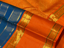 Vaibhogam- Gorgeous Peacock Blue with Orange Handwoven Pure Jari Korvai Kanjivaram Silk with Vairaoosi and Veldhari Striped body with rich doublepet borders with vairaoosi woven middle portions with gorgeous pallu and contrast woven beautiful blouse