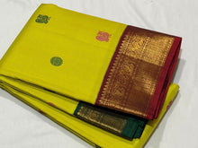 Vaibhogam- Stunning Lemoney Green tinted Yellow with Burgundy Maroon in a Handwoven Pure Jari Korvai Kanjivaram Silk with beautiful pattu buttas woven body rich borders gorgeous pallu and contrast woven blouse