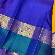 Vaibhogam-Gorgeous Golden Mustard with Peacock Blue and Violetish Blue Buttas Handwoven Pure Jari Korvai Kanjivaram Silk with Spaced borders rich pallu and contrast woven blouse. A very beautiful piece for this wedding season!