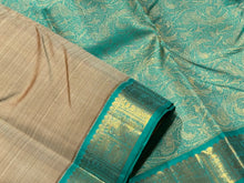 Beautiful Beige with Turquoise Green Handwoven Pure Jari Korvai Kanjivaram Silk with beautiful Yazhis and Annapakshis woven borders rich pallu and contrast woven blouse