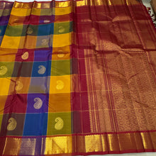 Vaibhogam- Stunning Palum Pazhamum checks in a unique and unusual palette of colors with paisley buttas woven body with rich bawanchi borders gorgeous and beautifully woven pallu in arakku with contrast checked arakku blouse
