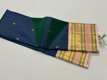 Deep Prussian Blue (dual tone of sapphire blue and green) with Soft Pink Buttas Handwoven Pure Jari Korvai Kanjivaram Silk Saree with rich meenakari varisaipet borders with vel, annam, manga, Neli streaks woven rich borders rich pallu and contrast woven