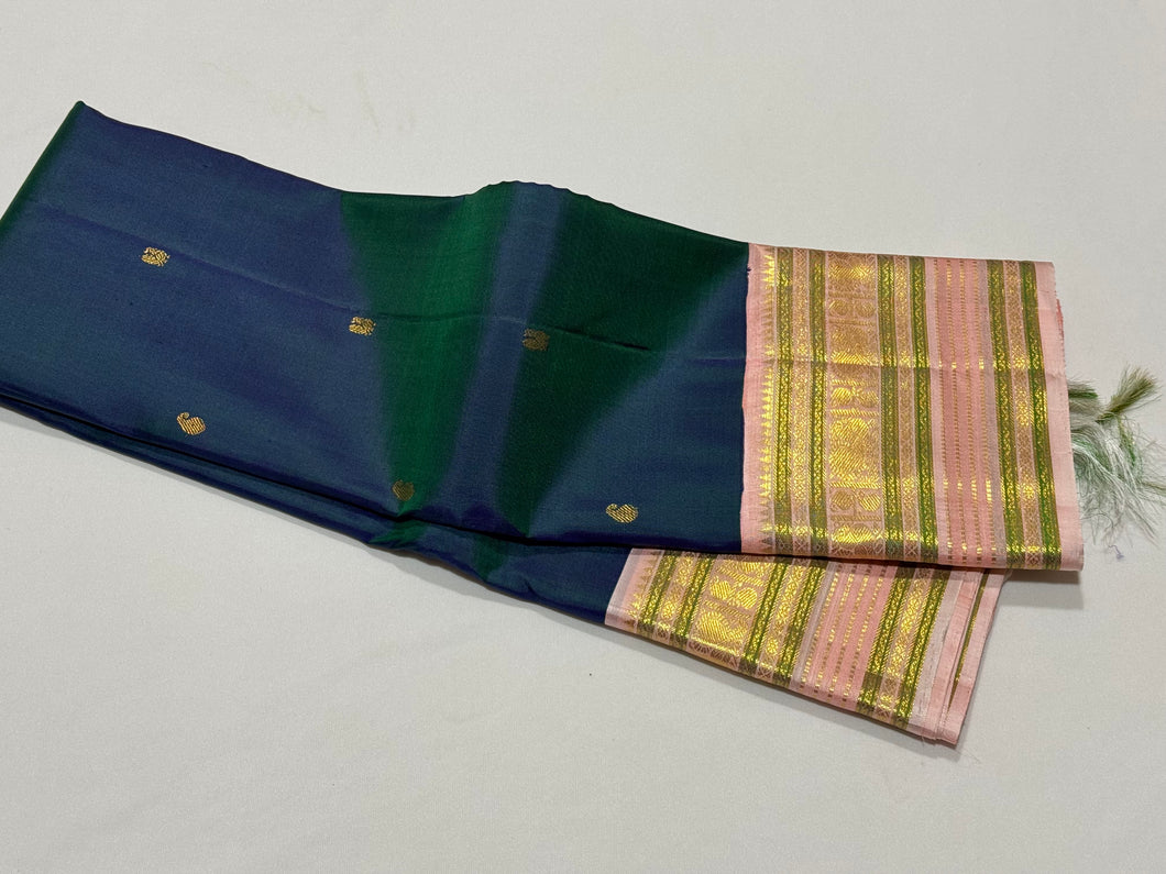 Deep Prussian Blue (dual tone of sapphire blue and green) with Soft Pink Buttas Handwoven Pure Jari Korvai Kanjivaram Silk Saree with rich meenakari varisaipet borders with vel, annam, manga, Neli streaks woven rich borders rich pallu and contrast woven