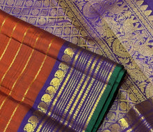 Sahana- Stunning  Rust Orange with Purple Handwoven Pure Jari Kanjivaram Silk with Jari Veldhari Body with rich borders pallu and contrast woven blouse