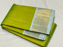 Mesmerizing Tender Leaf Green with Ice Blue combination with Vairaoosi woven gorgeous body with intricately woven borders with elephants and yazhi motifs with gorgeous pallu with yazhis elephants and peacocks woven with beautiful ice blue contrast blouse.