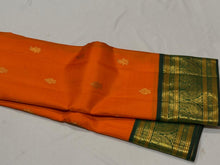 Vaibhogam- Stunning Orange with Bottle Green Handwoven Pure Zari Korvai Kanjivaram Silk with Buttas woven body with rich Borders gorgeous pallu and contrast green blouse