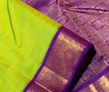 Sarasangi- Gorgeous Parrot Green with Violetish Purple Handwoven Pure 2g Jari Korvai Kanjivaram Silk with beautiful double peacocks woven borders rich pallu and contrast woven blouse