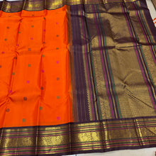 Vaibhogam- Mesmerizing Orange with Deep Coffee Brown Pure2g Jari handwoven Kanjivaram Silk with beautiful pattu buttas woven body with beautiful meenakari work woven rich borders and pallu and contrast woven beautiful blouse