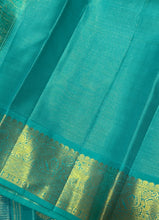 Vaibhogam- Gorgeous Navy Blue with Teal Handwoven Pure 2g Jari Korvai Kanjivaram Silk with Vairaoosi body with mayil chakram motifs woven body with beautiful borders rich pallu and contrast Vairaoosi woven blouse In teal