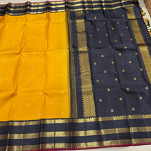 Vaibhogam- Stunning Yellow with Black Handwoven Pure 2g Jari Korvai with Buttas Kanjivaram Silk with beautiful triplepet borders with maroonish red selvedges rich pallu and a beautiful contrast black blouse