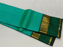 Vaibhogam- Beautiful Light Green with Dark Bottle Green Handwoven Pure Zari Korvai Kanjivaram Silk with beautiful spaced light and dark green double borders rich seer pallu and contrast woven bottle green blouse