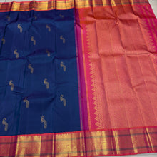 Vaibhogam- Gorgeous Peacock Blue with Orange Pink Handwoven Pure Jari Korvai Kanjivaram Silk with beautiful peacock buttas woven body with rich borders pallu and contrast woven blouse