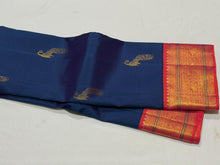 Vaibhogam- Gorgeous Peacock Blue with Orange Pink Handwoven Pure Jari Korvai Kanjivaram Silk with beautiful peacock buttas woven body with rich borders pallu and contrast woven blouse