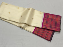 Vaibhogam- Stunning Offwhite with Fuchsia Pink Handwoven Pure Jari Korvai Kanjivaram Silk with beautiful buttas woven body with rich varisaipet borders beautiful pallu and contrast woven blouse with bottle green selvedges