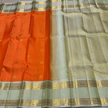 Vaibhogam-Gorgeous Orange with Elaichi Green Handwoven Pure Jari Korvai Kanjivaram Silk with beautiful buttas woven body with rich rudrakshas and jari lines striped borders gorgeous pallu and contrast woven blouse