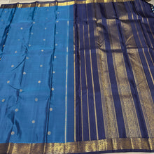 Vaibhogam- Mesmerizing Royal Azure Blue with Navy Blue Handwoven Pure 2g Jari Korvai Kanjivaram Silk with Buttas woven body with beautiful small intricate borders rich pallu and contrast navy blue blouse