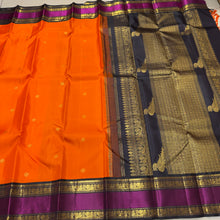 Vaibhogam- Stunning Fanta Orange with Kanchana Black Handwoven Pure Jari Korvai Kanjivaram Silk with beautiful buttas woven body with intricate doublepet with middle silk thread woven borders gorgeous kalakshetra parrots woven pallu and contrast blouse